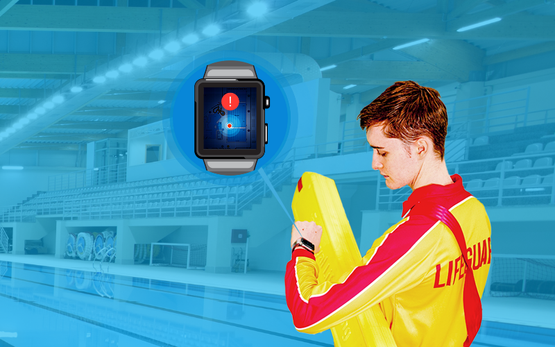 A lifeguard stands in front of a public swimming pool, looking at his watch. To his left a graphich shows a zoomed in picture of the watch face. On the watch is a red triangle with an exclamation point inside.