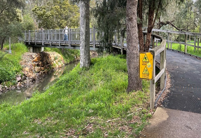 Safe walkway adjacent and over waterway image