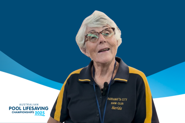 A photo of Nerida Murry, with the Sydney Olympic Park pool behind her.