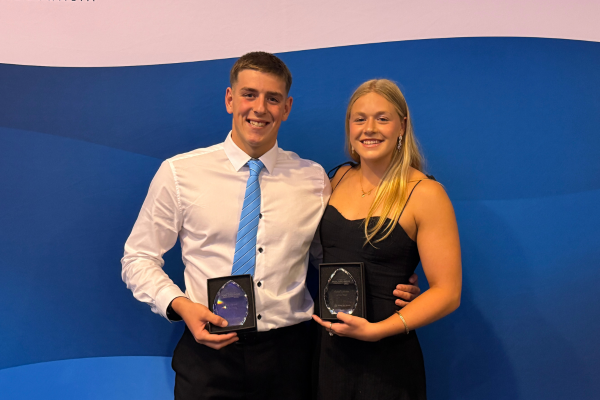 A photo of Jemma Holt and Brayden Woodford, holding their awards, at the APLSC 2025 awards ceremony.